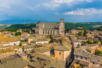 The cathedral in Orvieto, Italy towers above the surrounding roof tops in summer