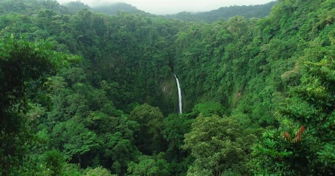 La Fortuna Waterfall in the rainforest near Arenal Volcano in Costa Rica, Central America. Beautiful nature landscape at toursit travel destination landmark.