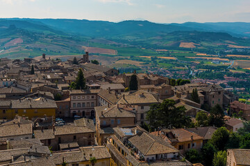 Fototapeta na wymiar The roof tops of Orvieto, Italy rise above the surrounding countryside in summer