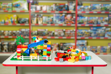 Plastic toy blocks on the white table in the store.