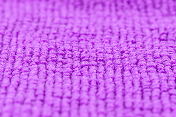 Background made of purple microfiber fabric, selective focus.
