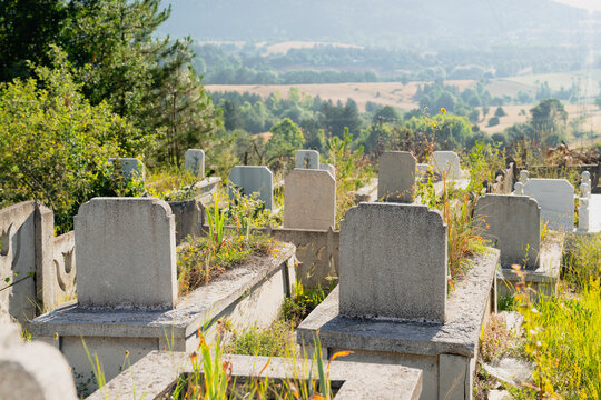 Country cemetery with green plants in Turkey at sunset