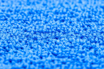 Background made of blue microfiber fabric, selective focus.