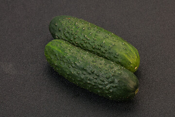 Green fresh cucumbers over background