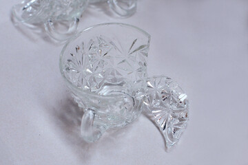 Shattered broken crystal glass cups isolated on a white background