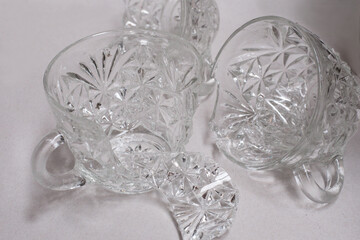 Shattered broken crystal glass cups isolated on a white background