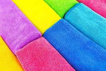 Background made of different colors of microfiber material stacked side by side, top view.