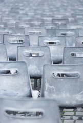 Empty plastic chairs outdoors on rainy day