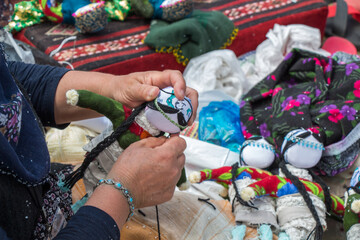 woman sewing making handmade  doll from  frabric