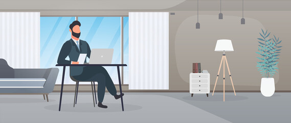 A guy with glasses sits at a table in his office. A man works on a laptop. Office, sofa, bookshelf, business man, floor lamp. Office work concept. Vector.