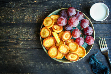 Mini pancakes cereal sweet breakfast snack dessert Menu serving. food background top view copy space