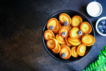 Mini pancakes cereal sweet breakfast snack dessert Menu serving. food background top view copy space