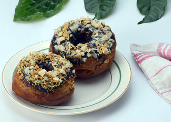 Two Chocolate Donuts with Various Topping. On whitel background