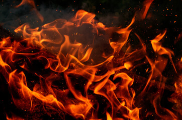 Texture of orange and red flames from a wood fire outdoors, template for graphic use of flames or...