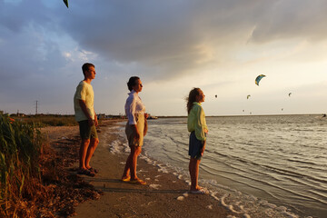 family on the beach watching the sunset