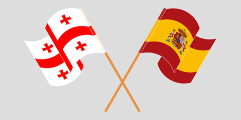 Crossed and waving flags of Georgia and Spain