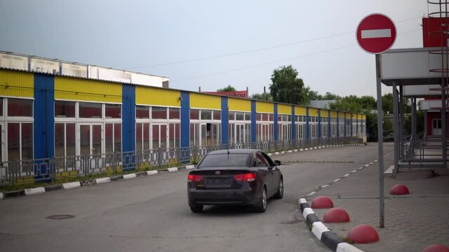 The car passes under a prohibiting road sign.