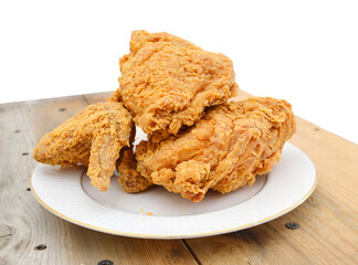 fried chicken on a plate on wooden board