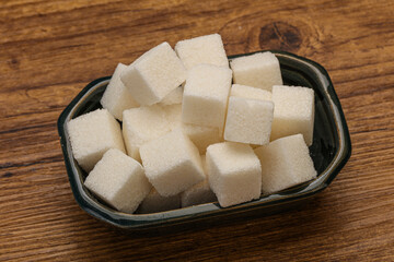 Refined white sugar cubs in the bowl