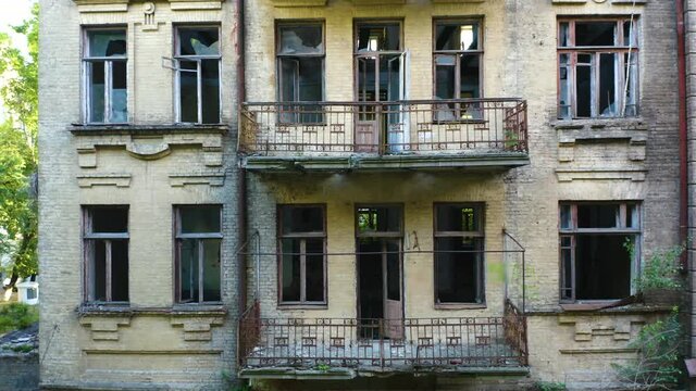 Abandoned old commercial apartment building in the Art Nouveau style (Modern Style) with a broken windows. Deserted house of the turn of the 19th and 20th centuries. Aerial side view