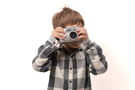 little boy with a camera in his hand. on a white background