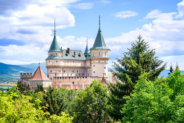 Fototapeta na wymiar View of neogothic Bojnice castle over treetops of Castle park (Bojnice, Slovakia)