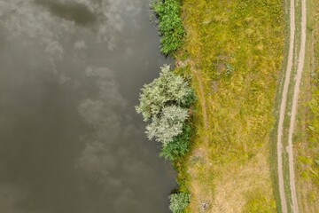 Rural aerial landscape on a hot summer day. Green country side with river and road. Aerial view.