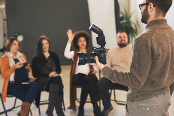 Attendees attending a photography course in studio.