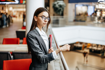 Businesswoman with documents for work. Student girl with folders with documentation. An officer...