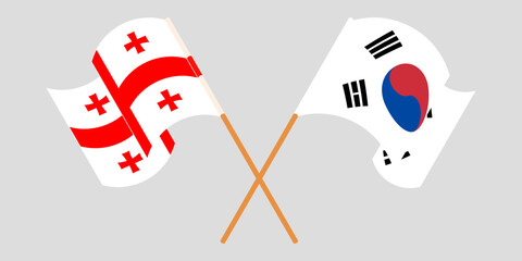 Crossed and waving flags of Georgia and South Korea