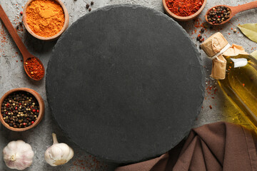Composition with spices and round cutting board on gray background, space for text