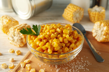 Composition with fresh raw corn on white wooden background, close up