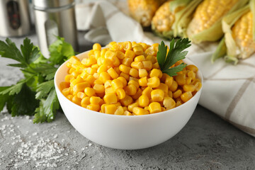 Composition with fresh raw corn on gray background, close up