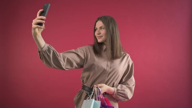 irl walks through the store with purchases and takes a selfie. Blogger girl.