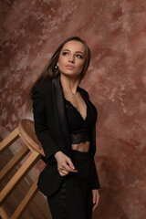 beautiful brunette girl in a black suit, business lady