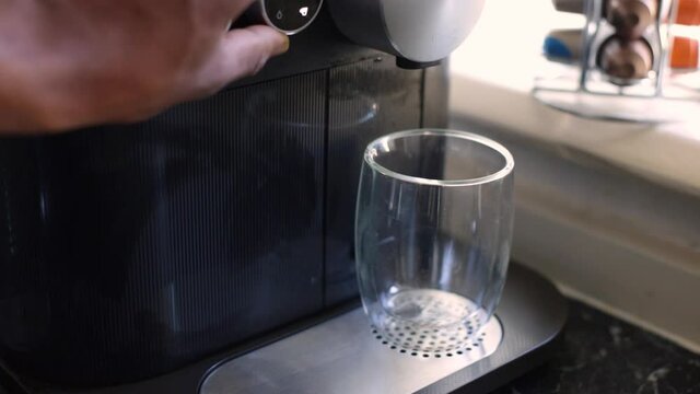 Espresso coffee being made with a nespresso machine