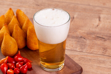 traditional Brazilian fried snack made with chicken known as "coxinha" and Little-Beak Peppers Brazil called "Pimenta Biquinho"