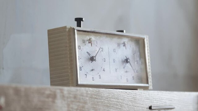 Male Hand Presses the Old Chess Clock
