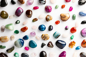 Fototapeta na wymiar Colorful semi-precious stones arranged neatly on a white background