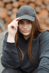 Fashion elegant woman wearing a black jacket and black hat. High quality photo