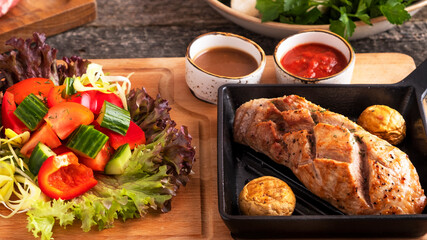 Roasted beef tenderloin garnish with fresh vegetables and sauces. Closeup