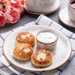 Cottage cheese pancakes with sour cream. Breakfast time. Healthy and diet food concept