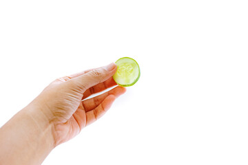 cucumber slices are held by the left hand. isolated white background. copyspace