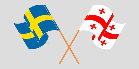 Crossed and waving flags of Georgia and Sweden