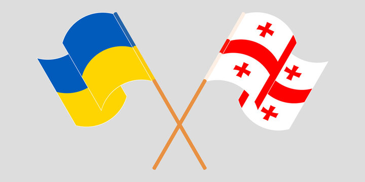 Crossed and waving flags of Georgia and the Ukraine
