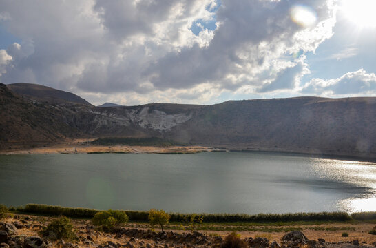 Amazing Volcanic lake Nar with emerald water in the crater of an extinct volcano surrounded by mountains in Aksaray Province of Cappadocia. Travel to Turkey