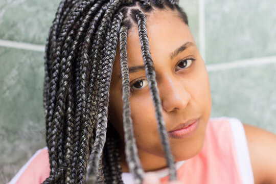 Selective focus on hair. Portrait of a young afro woman with box braids  Stock Photo