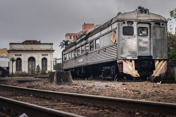 An old abandoned train in train tracks