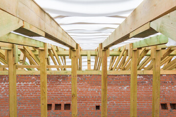 Rafter system of a wooden roof. Wooden construction. The construction of the roof of a residential building.