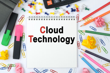 On the table is a calculator, diary, markers, pencils and a notebook with the inscription - Cloud Technology
